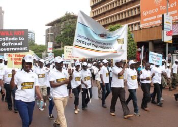 Demonstrators on an anti-corruption march carrying banners addressed to government.