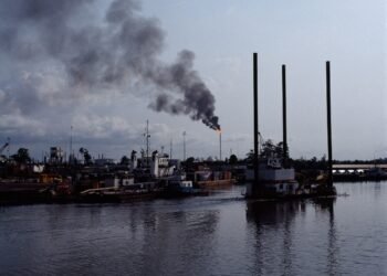 A burning gas flare and black smoke over Nembe Creek, Niger Delta, Nigeria.
