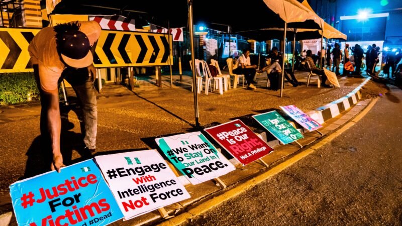 Placards at a memorial for victims of the Special Anti-Robbery Squad in Nigeria.