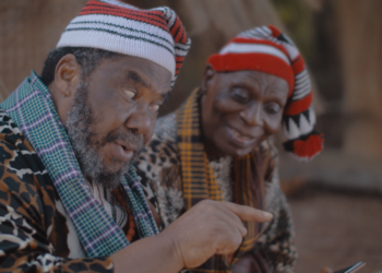 Two Igbo elders in a dramatised scene illustrating Achebe's Things Fall Apart.
