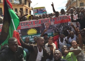 Indigenous People of Biafra supporters marching with Biafran flags behind an IPOB Anambra State Chapter banner.