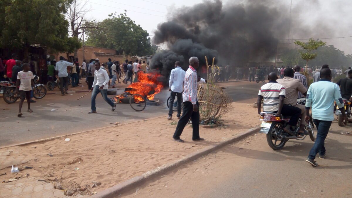 Demonstrators and a burning barricade on a street in Niamey, Niger.