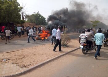 Demonstrators and a burning barricade on a street in Niamey, Niger.