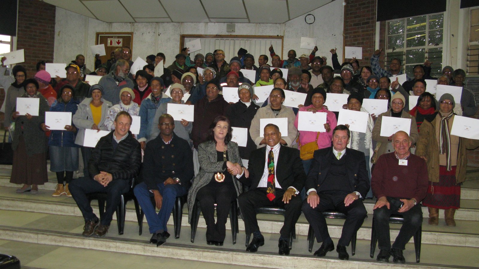 A land title deed handover ceremony in Grabouw, South Africa.