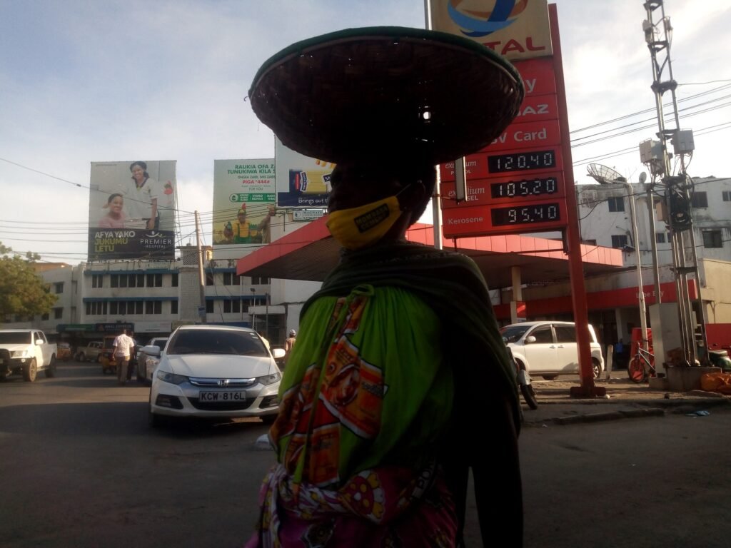 Street traders and motorbikes amid rising fuel costs in Africa.