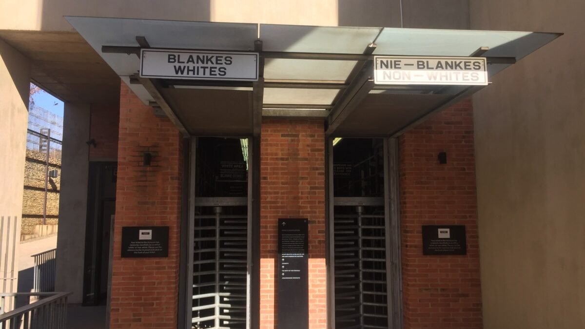 Segregated entrance turnstiles marked Blankes and Nie-Blankes at the Apartheid Museum, Johannesburg.