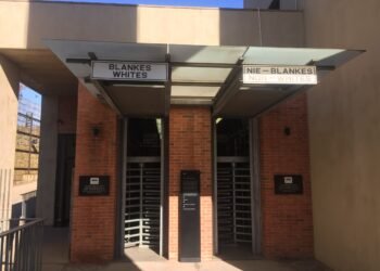 Segregated entrance turnstiles marked Blankes and Nie-Blankes at the Apartheid Museum, Johannesburg.