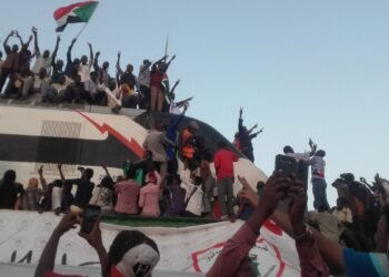 Demonstrators crowding the roof of the revolution train arriving from Atbara, Sudan.