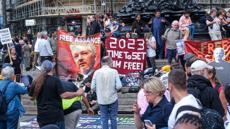 Banners and demonstrators supporting Julian Assange at Piccadilly Circus, London.