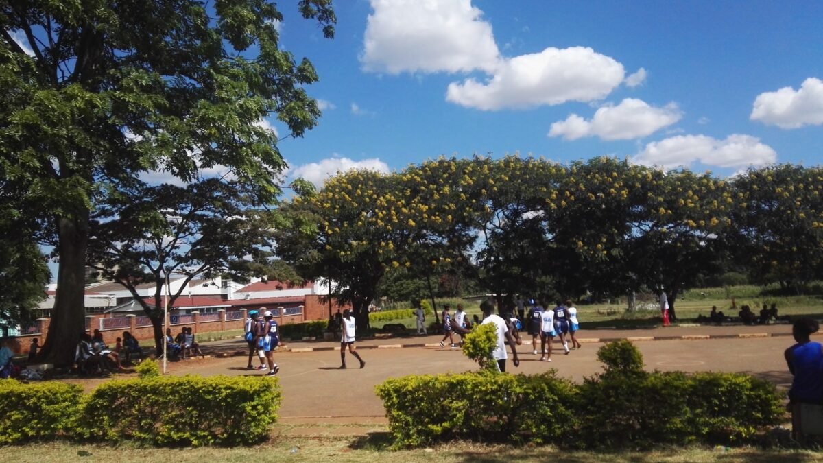 Girls playing competitive netball at a school ground in Africa.