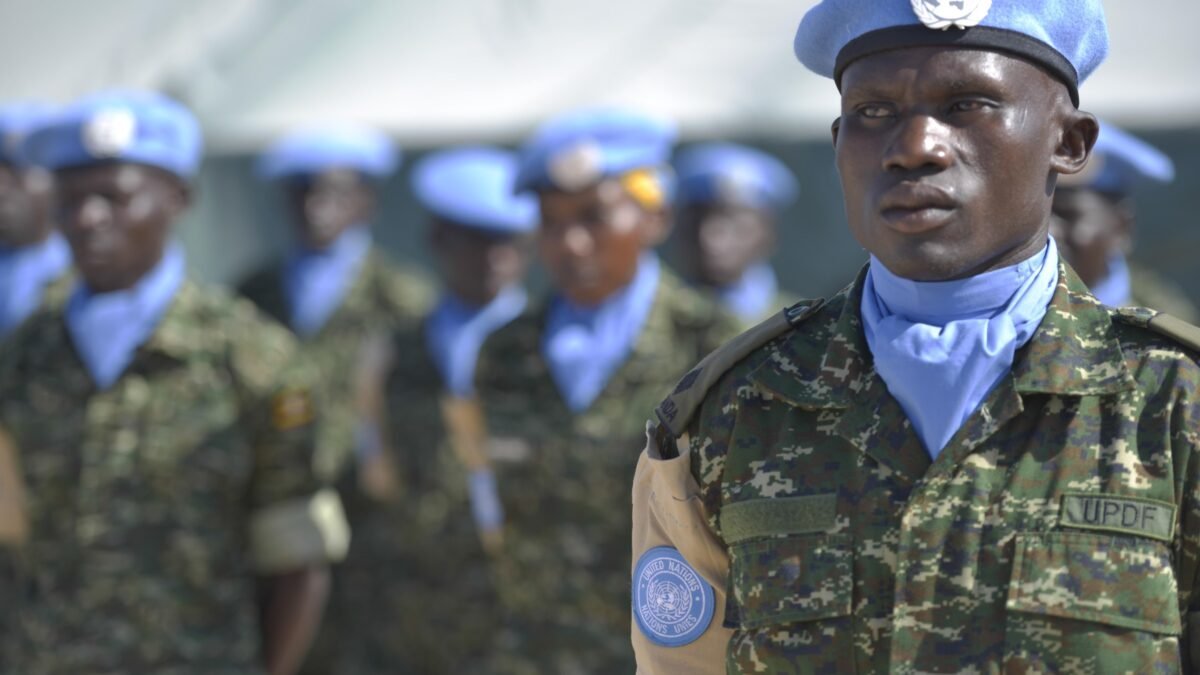 A Ugandan soldier in a United Nations blue beret at a guard unit inauguration ceremony.