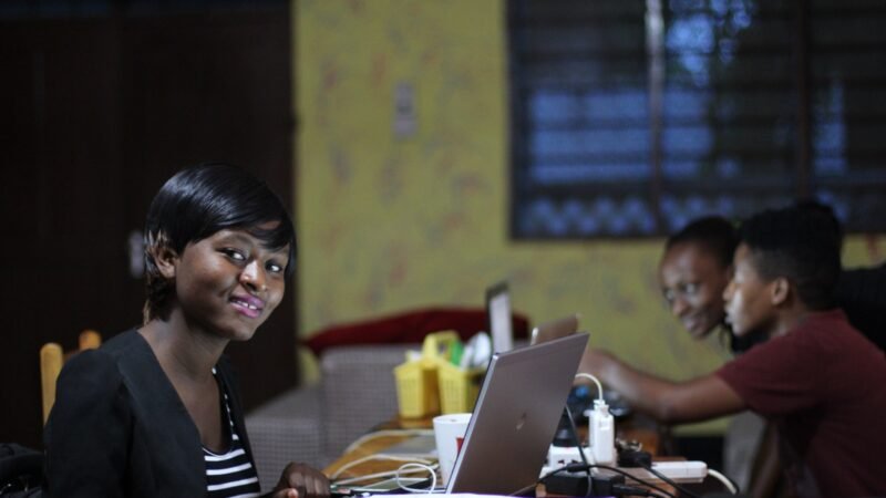 Young people working at laptops in a shared workspace in Africa.